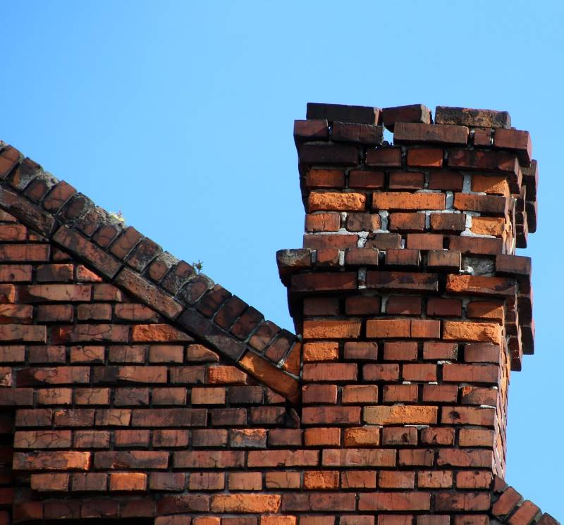 Damaged chimney on an Lincoln Park home showing cracks and missing mortar